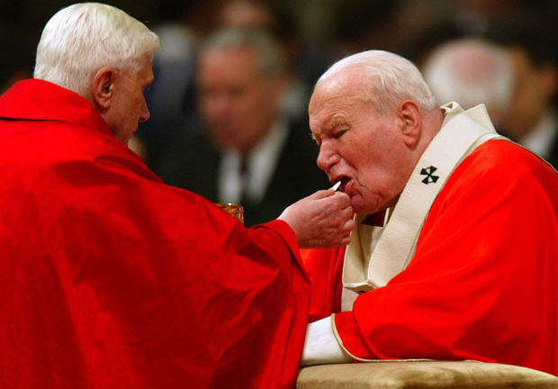 Joseph Cardinal Ratzinger giving Pope John Paul II Holy Communion.